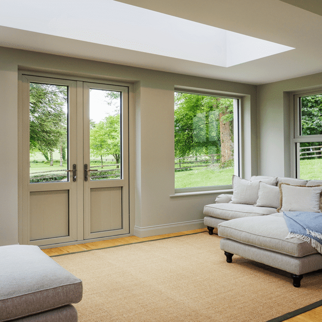 Spacious hotel lounge with cosy sofas, large windows overlooking lush greenery, inviting natural light for a relaxing stay.